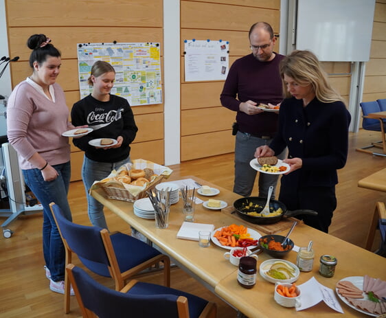 Mitarbeiter der Verwaltung lassen sich das Frühstück schmecken